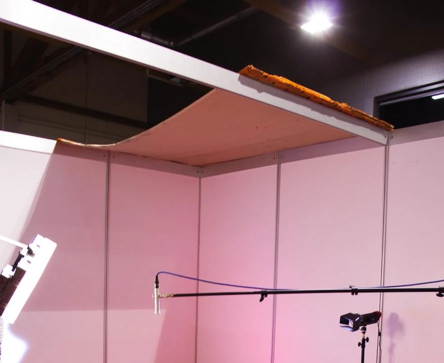 Improvised interview studio built from trade-show partition walls backstage at the Kärntenhalle